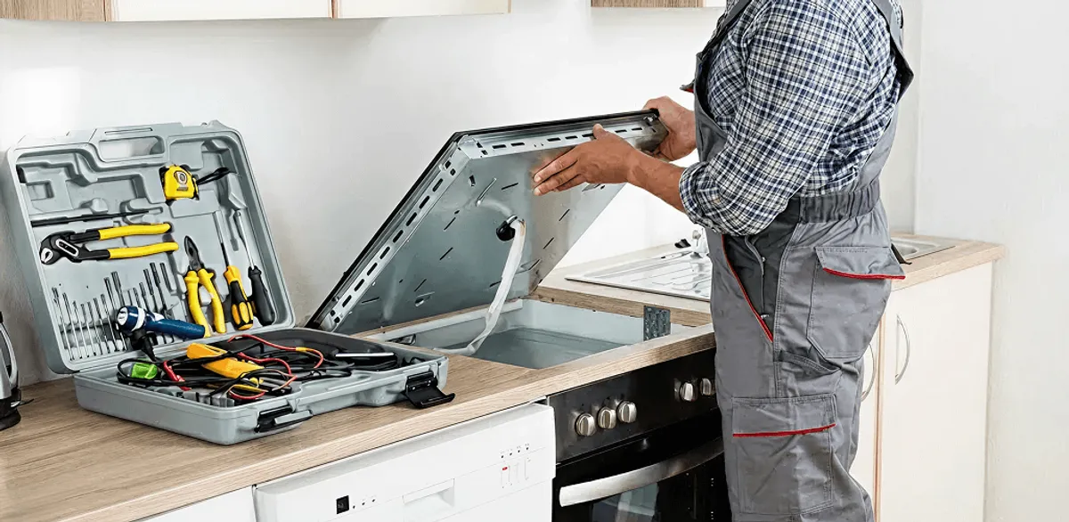 Handyman repairing a cooktop and checking wiring connections in Milwaukee, WI