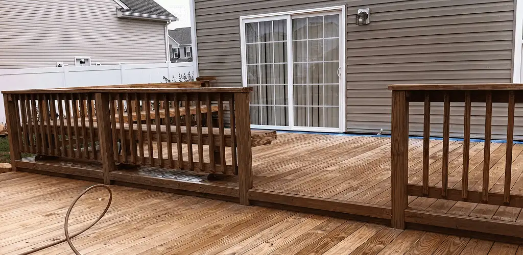 Deck sealing service protecting a backyard wood deck and railings in Milwaukee, WI