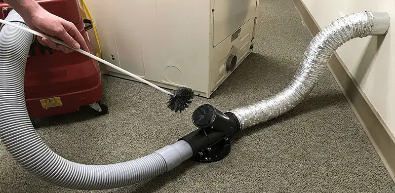 Dryer vent cleaning service removing lint from a dryer duct connection in Milwaukee, WI