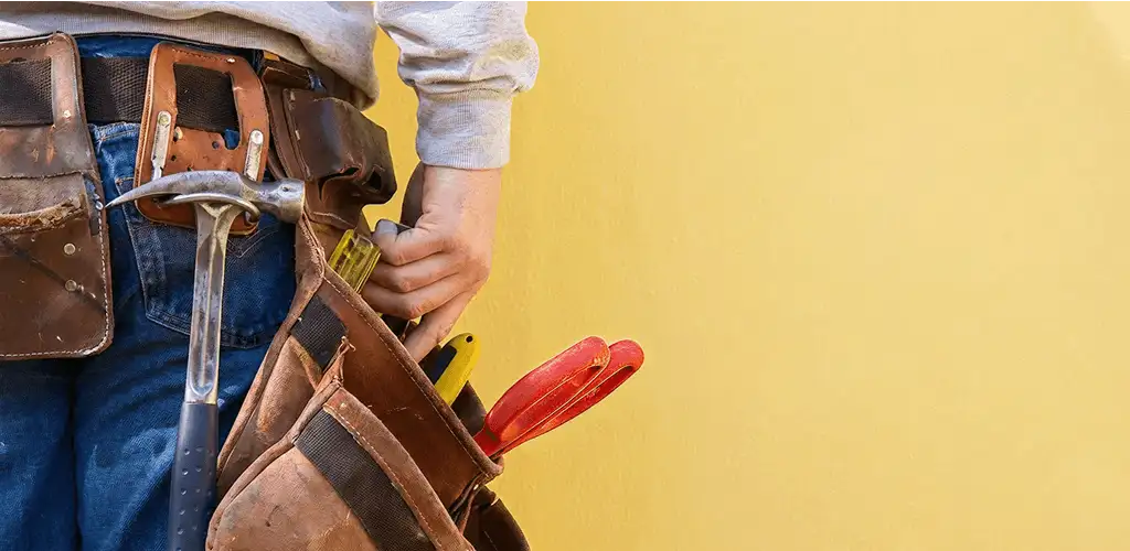 Handyman with tool belt ready for home repairs and maintenance in Milwaukee, WI