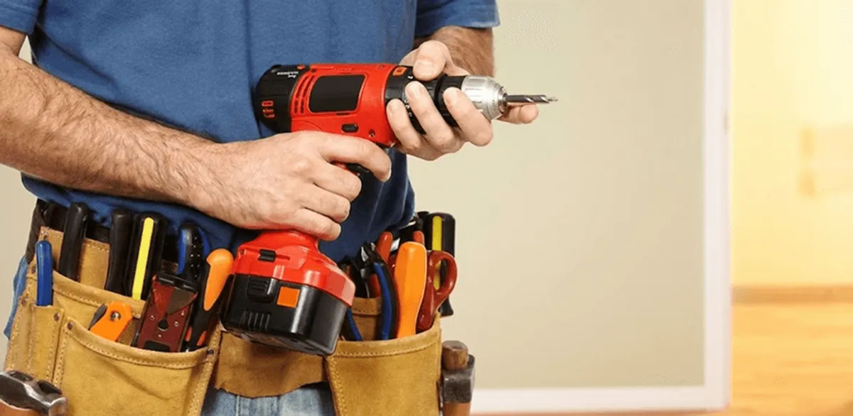 Handyman holding a power drill for home repairs and installations in Milwaukee, WI