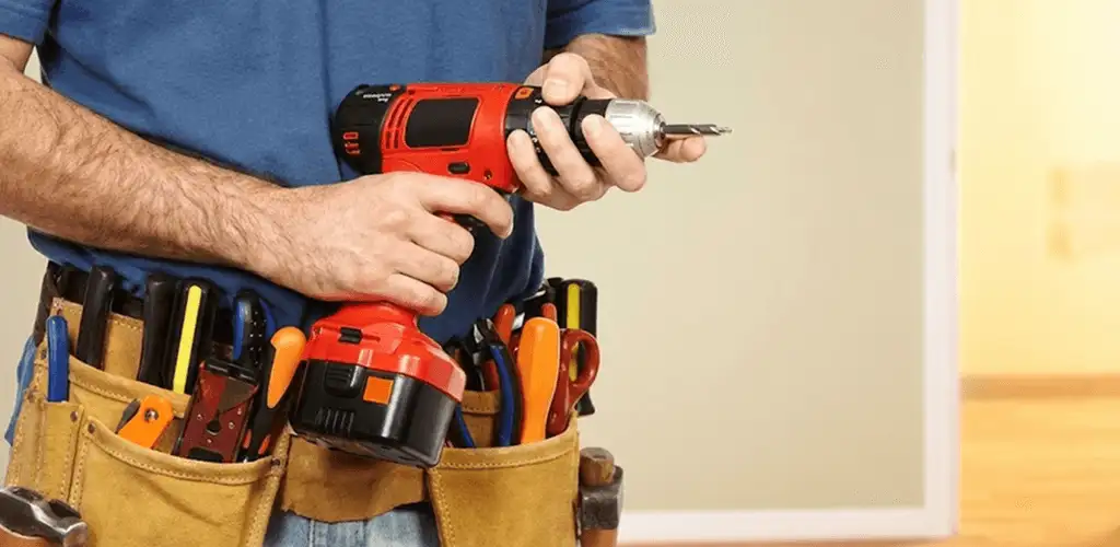 Handyman holding a power drill for home repairs and installations in Milwaukee, WI