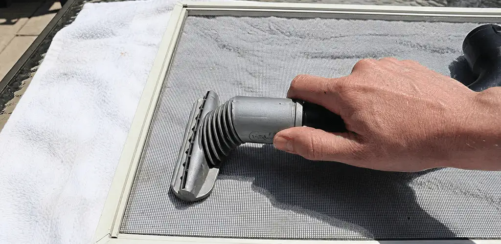 Window screen repair cleaning and fixing a damaged screen mesh in Milwaukee, WI