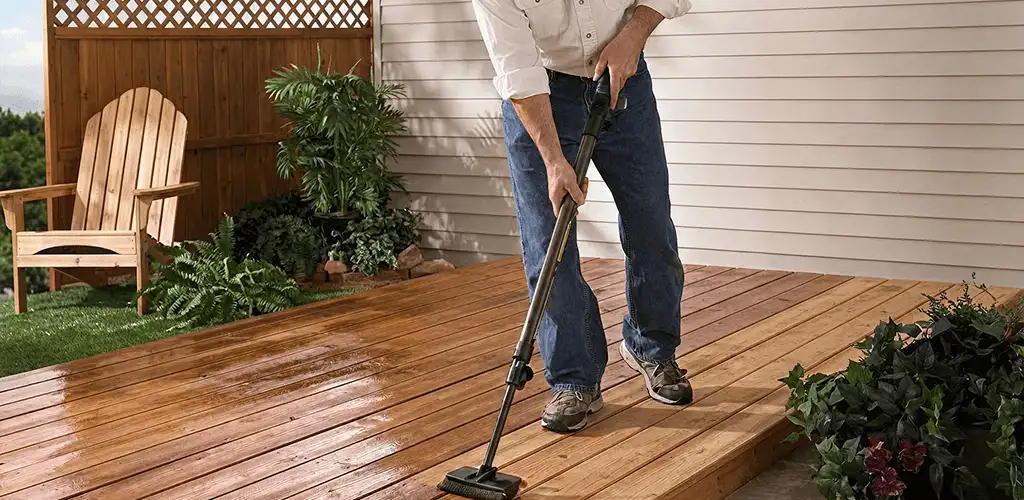 Deck staining service applying stain to a backyard wood deck in Milwaukee, WI